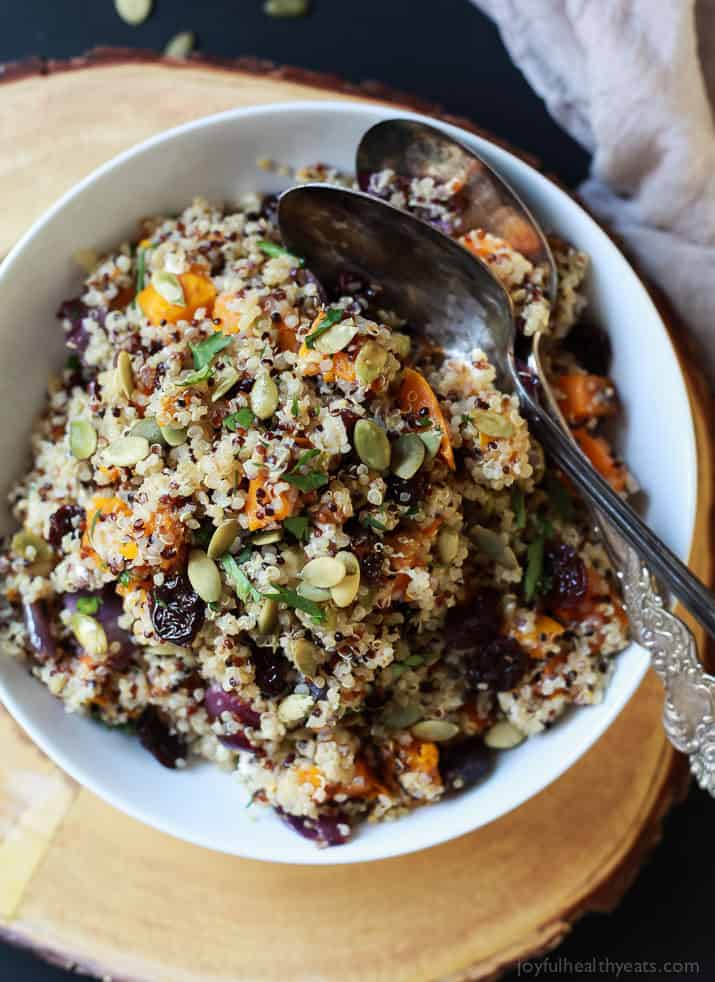 The BEST Roasted Butternut Squash Quinoa Salad with a secret creamy element and surprise spice that makes this salad dish pop with flavor. This Quinoa Salad is a rock star gluten free vegetarian recipe you need on your table this fall. | joyfulhealthyeats.com #recipes