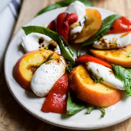 A light, refreshing, irresistible Roasted Red Pepper Peach Caprese drizzled with a homemade Balsamic Reduction. It's like a flavor bomb went off in your mouth! | joyfulhealthyeats.com #glutenfree #vegetarian