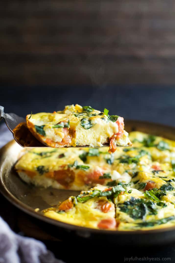ROASTED TOMATO CAPRESE FRITTATA, an easy yet fancy looking holiday recipe that's perfect for breakfast, brunch or lunch! Filled with melted mozzarella, fresh basil, garlic infused spinach and roasted tomato - it's pretty much divine! | joyfulhealthyeats.com