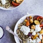 Roasted Vegetable Grain Bowls – a gluten free grain bowl filled with spiced roasted vegetables then covered in a creamy Tzatziki Sauce. A meal your family will love and perfect for meatless Monday!