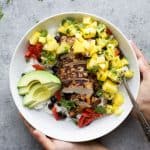 Head to Jamaica with this Grilled Jerk Chicken Bowls topped with Mango Pineapple Salsa served over Coconut Rice. An easy gluten free weeknight meal your family will love! | #ad @justbarechicken