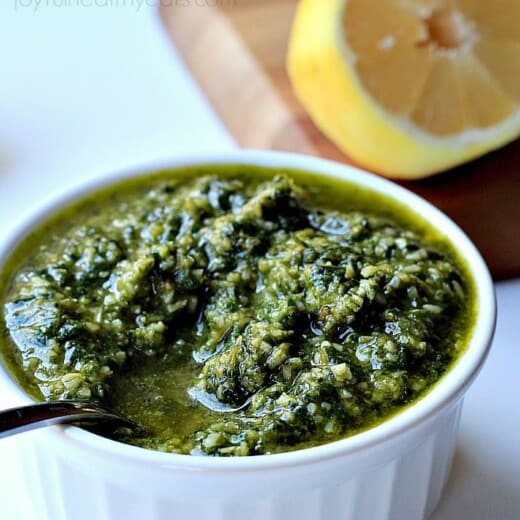 Basil Pesto in a Small White Dish Beside Half a Lemon