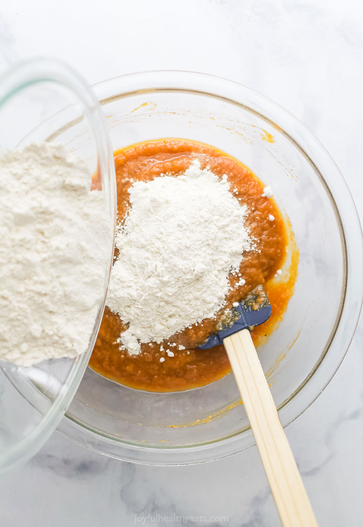 Adding the flour to the wet mixture. 