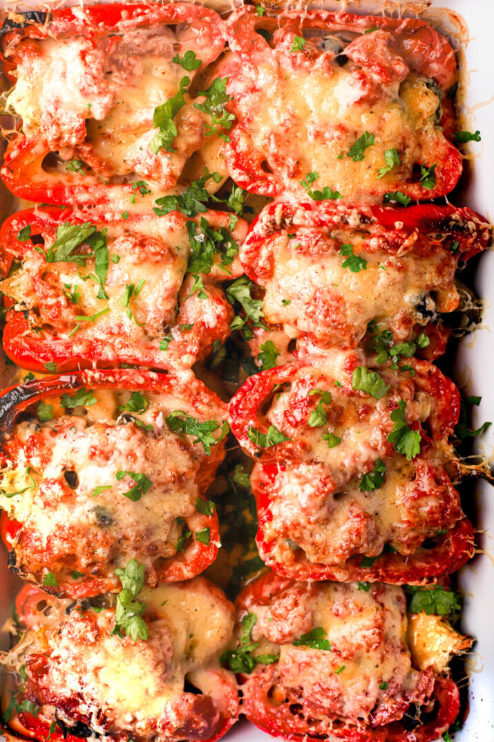 A close-up shot of homemade stuffed peppers inside of a baking dish
