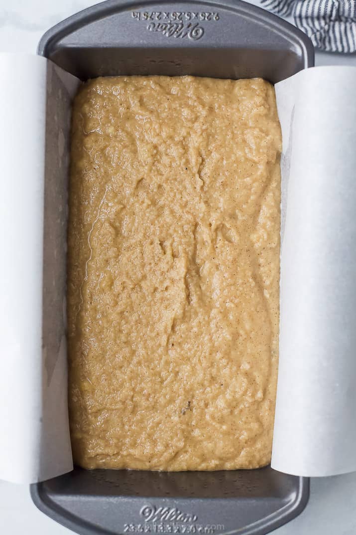 Paleo Banana Bread Batter in a Loaf Pan Lined with Parchment Paper