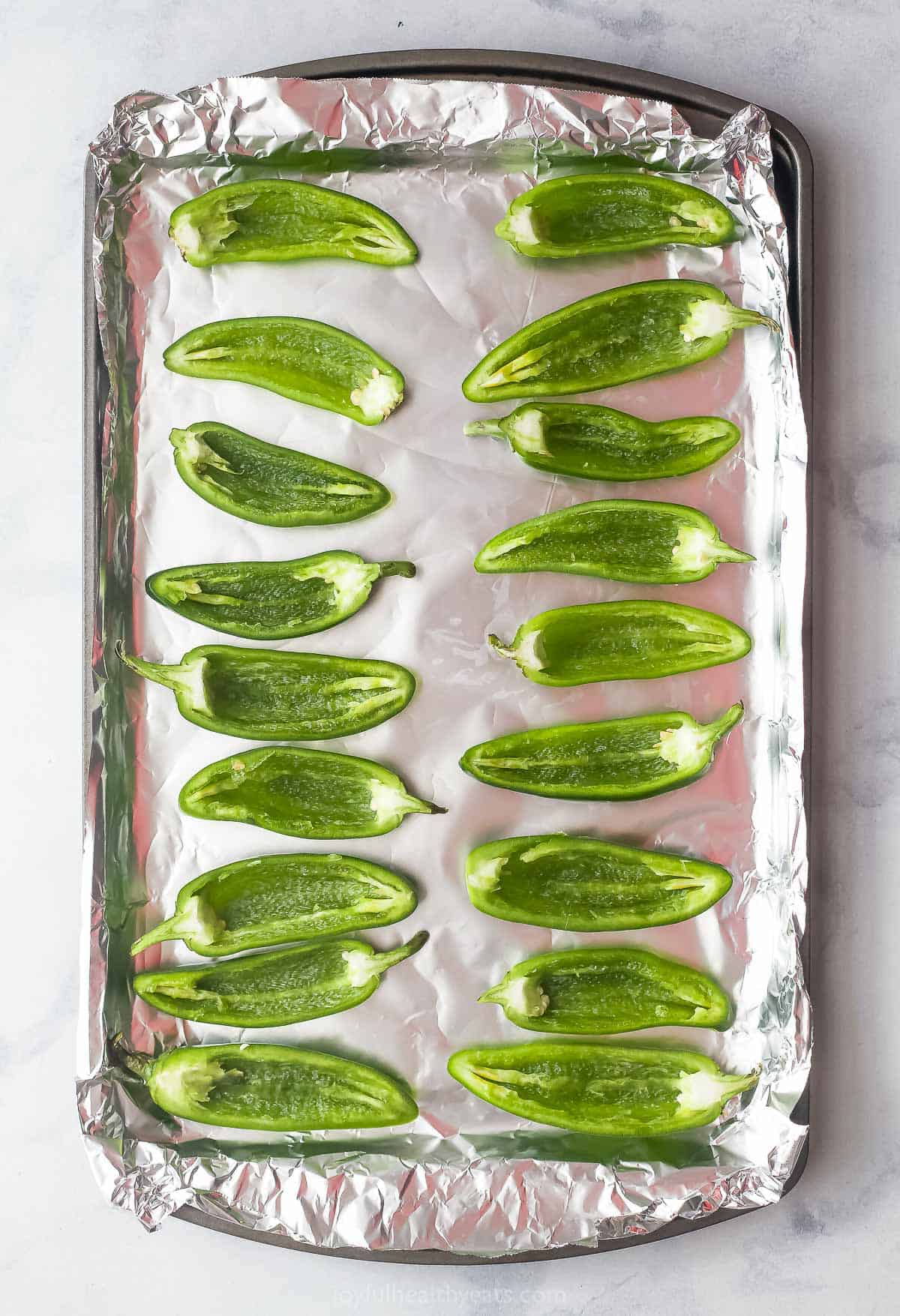 Seeded jalapenos on the baking sheet. 