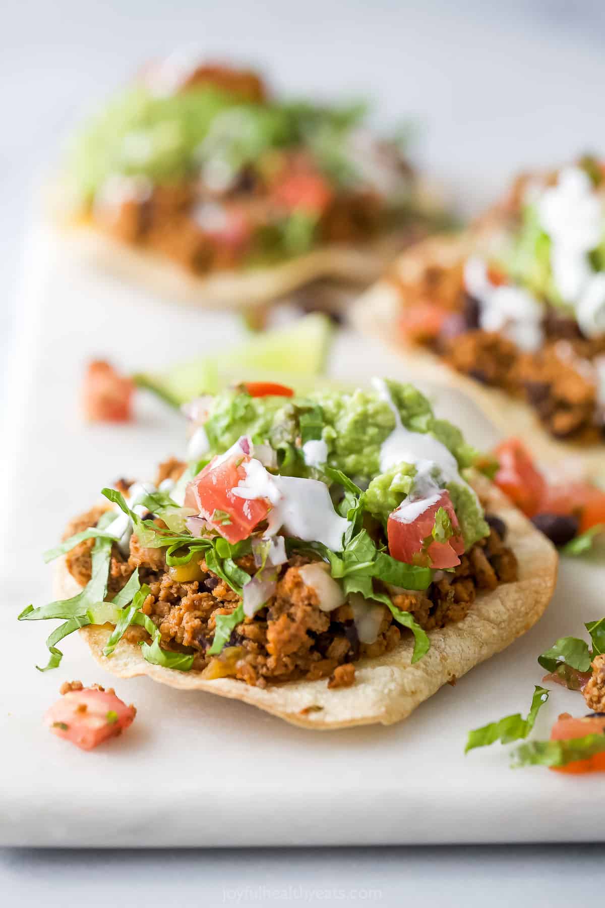 Close-up of a turkey tostada with toppings.