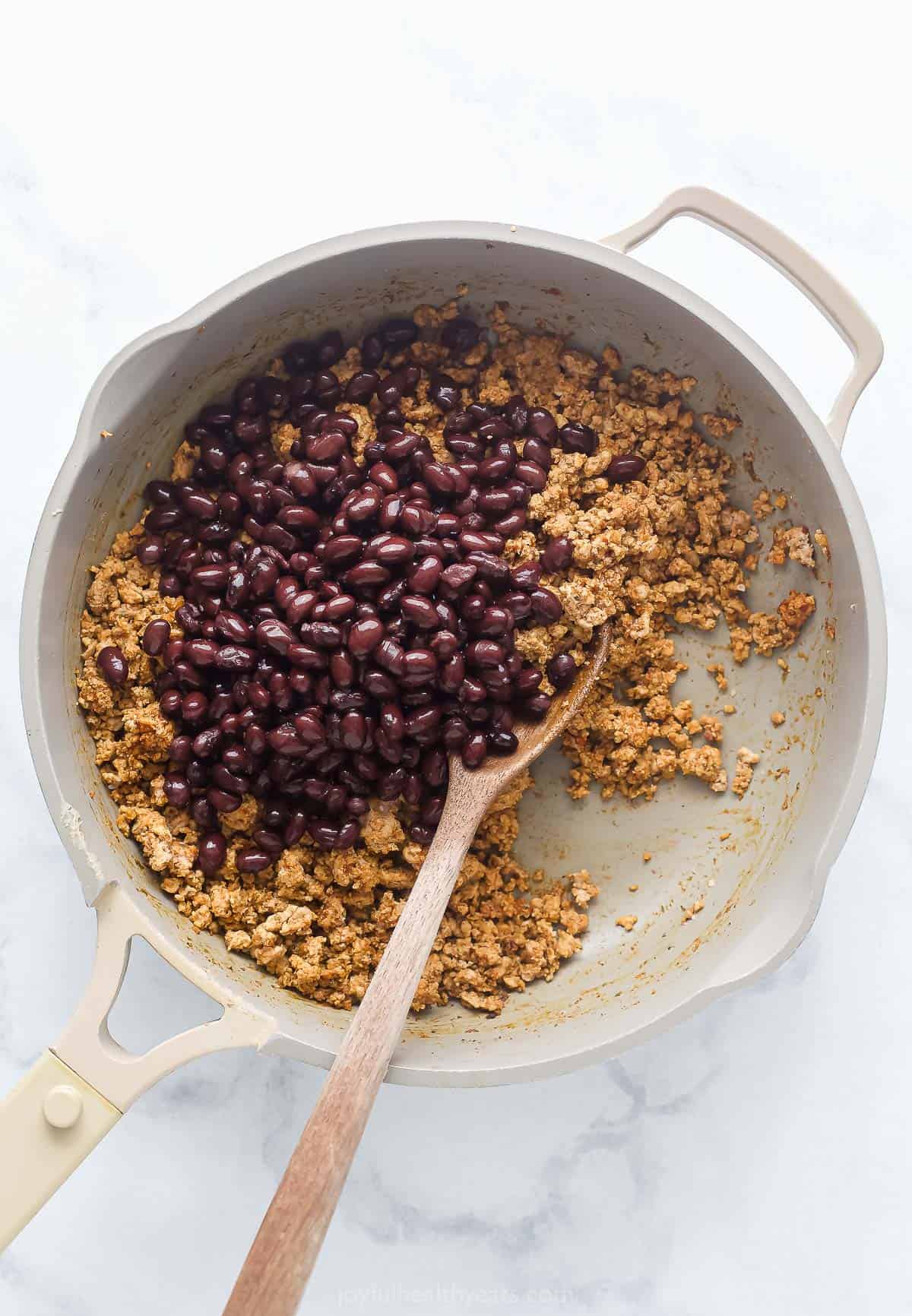 Stirring in the beans. 