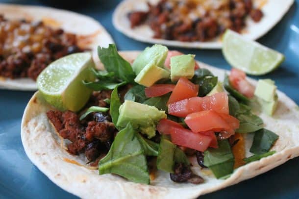 A Turkey Tostada with tomato and avocado on top