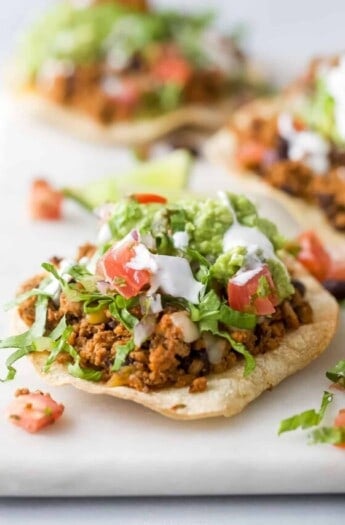 Close-up of a turkey tostada with toppings.