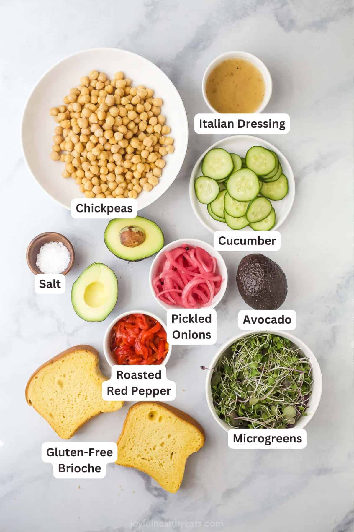 This Avocado Sandwich is the perfect quick lunch, with smashed chickpeas for protein, smoky roasted red peppers, and tangy pickled onions. Overhead view of ingredients for avocado sandwich