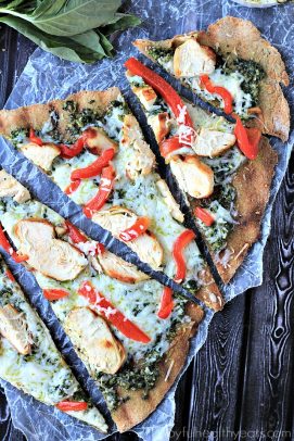 Five Slices of Grilled Chicken Pesto Pizza on a Wooden Surface