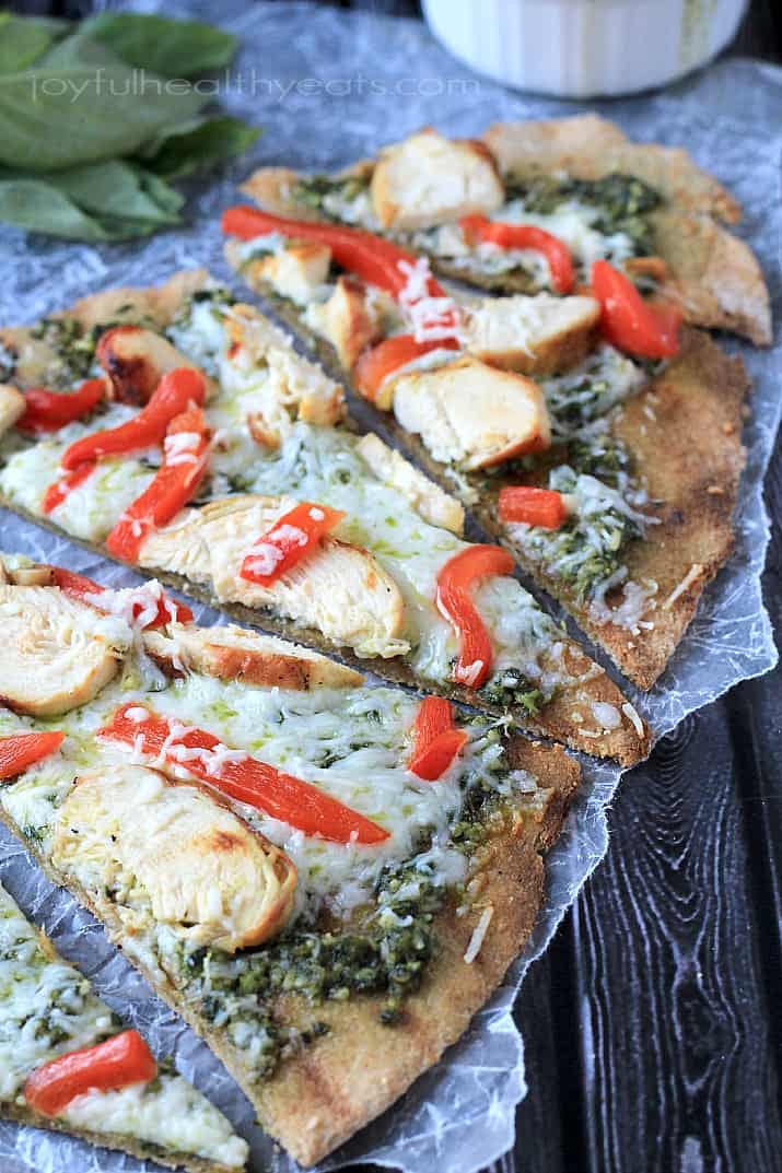 Slices of Grilled Chicken Pesto Pizza on wax paper