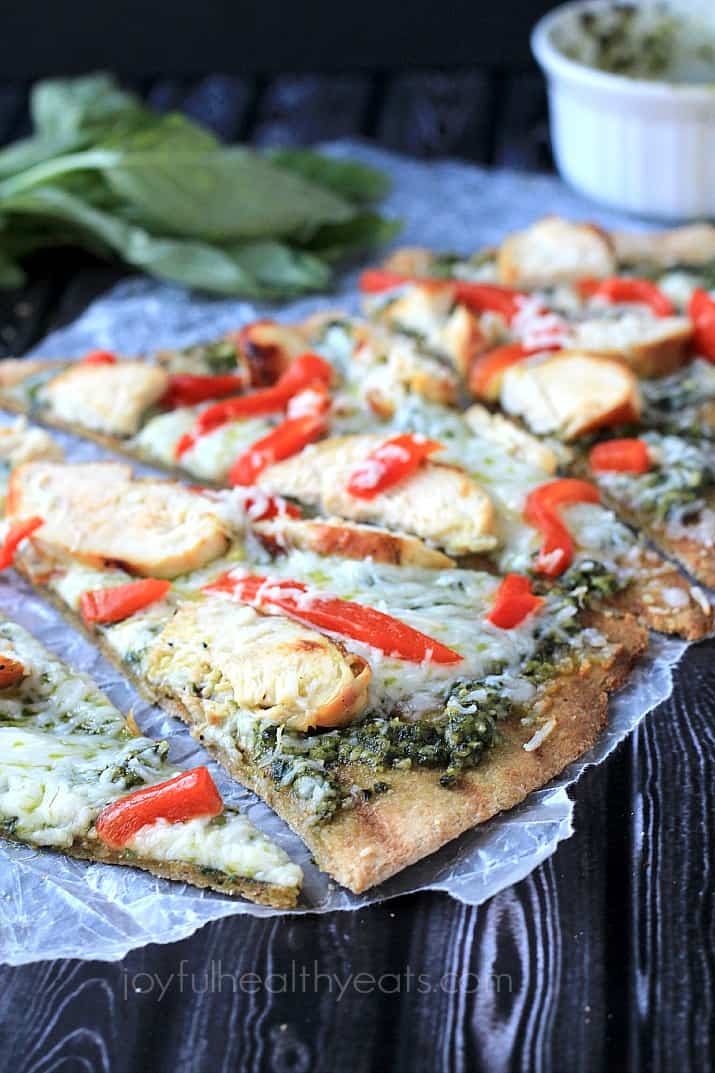Slices of Grilled Chicken Pesto Pizza on wax paper