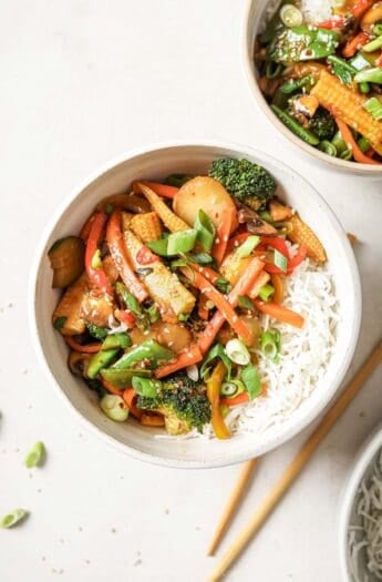 Overhead view of vegetable stir fry in bowl with rice