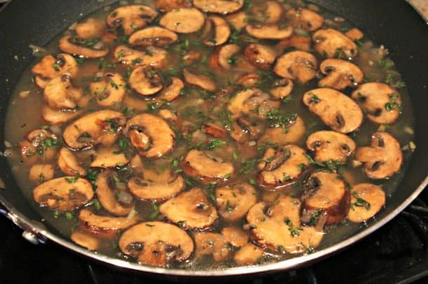Mushrooms Cooking Over the Stove with Chicken Broth