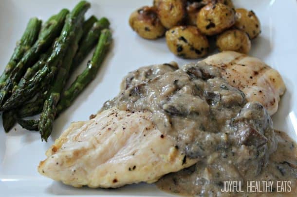 A Plate of Chicken with Creamy Mushroom Sauce and Veggies on the Side