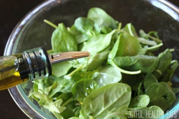 Image of Adding Olive Oil to Spinach & Arugula Salad
