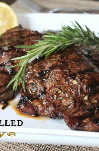 Two Tuscan Grilled Steaks Garnished with a Sprig of Rosemary