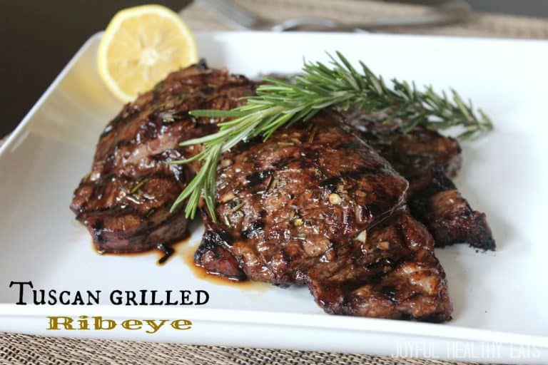 Two Tuscan Grilled Steaks Garnished with a Sprig of Rosemary