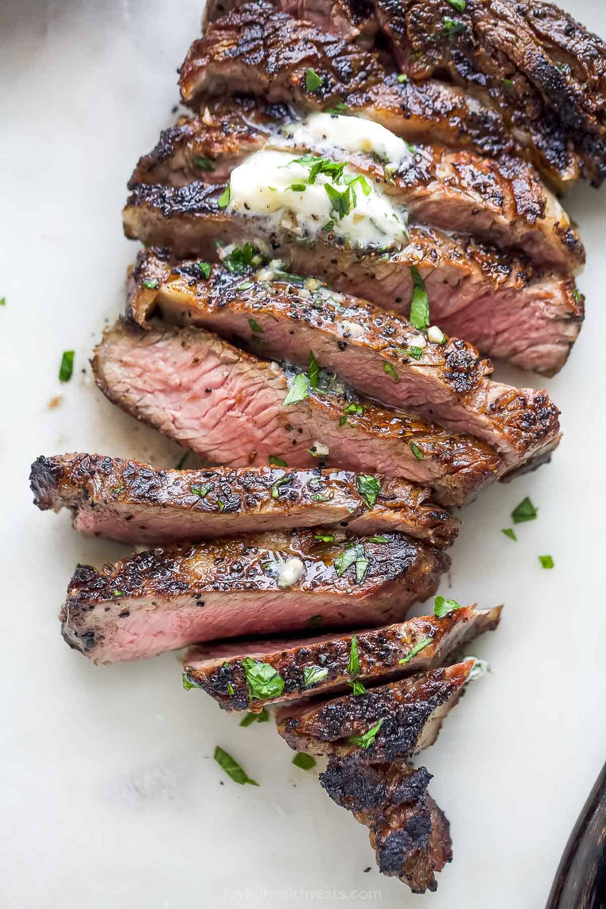 Angled photo of tender grilled ribeye, sliced. 