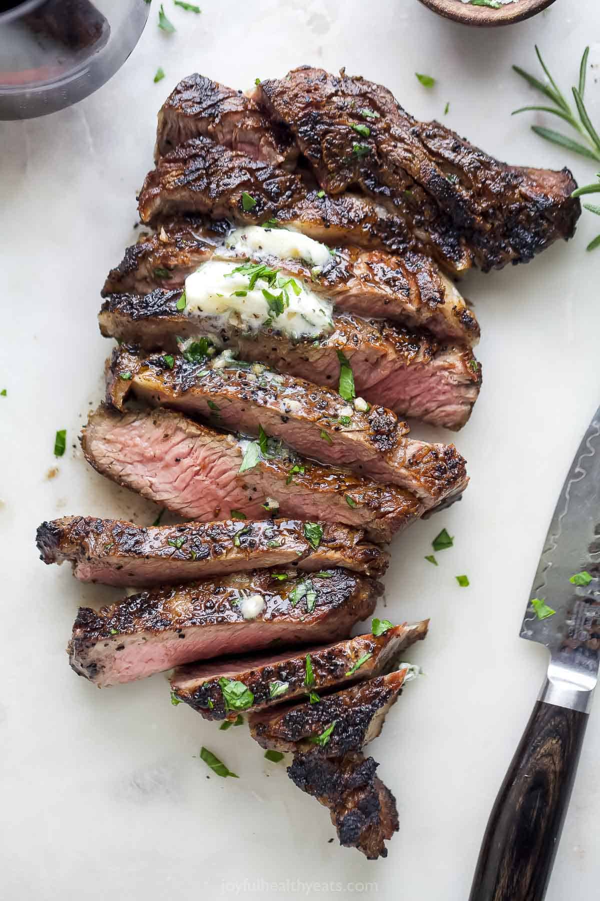 A sliced grilled ribeye recipe with grill marks. 