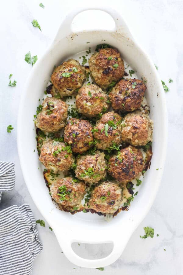 Baking dish with freshly baked herby turkey meatballs.
