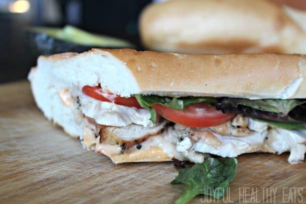 Close-up view of a Grilled Chicken Sandwich on a hoagie roll with lettuce and tomato