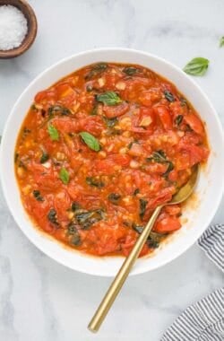 Overhead view of homemade pasta sauce in bowl with spoon