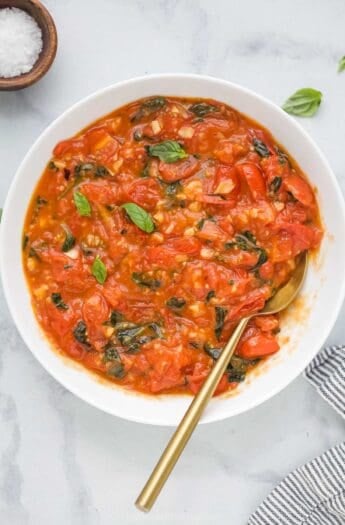 Overhead view of homemade pasta sauce in bowl with spoon