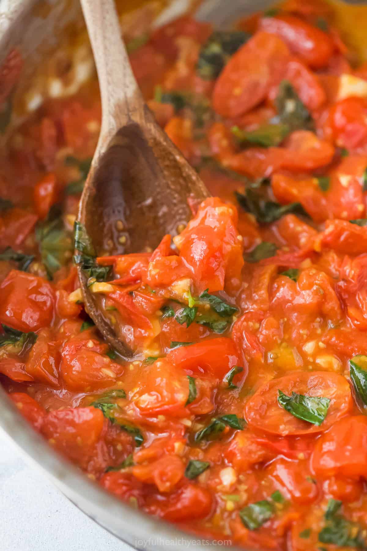 When you got this trusted pasta sauce recipe you will never buy a jar in the store again! Tomatoes, basil and lots of garlic make it delicious. Spoon scooping homemade pasta sauce