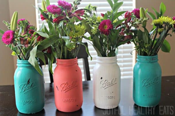 Four Brightly Painted Mason Jars Filled with Flower Bouquets