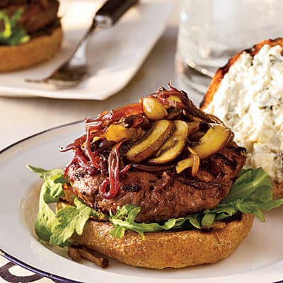A Cabernet Balsamic Burger on a White Plate with a Navy Blue Rim