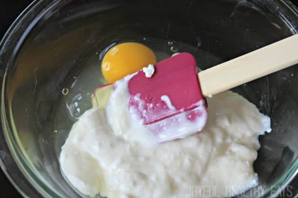 Yogurt and raw egg in a mixing bowl