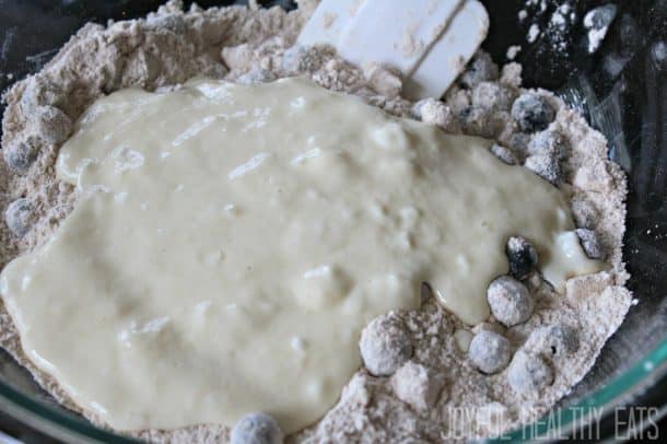 Dry ingredients, fresh blueberries, and yogurt mixture in a mixing bowl