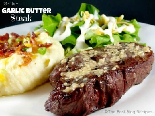 A Grilled Garlic Butter Steak on a Plate with Salad and Mashed Potatoes