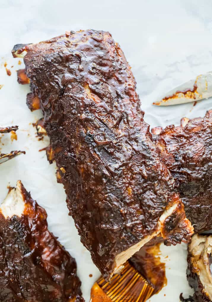 overhead photo of the ultimate baby back ribs with bbq sauce all over it