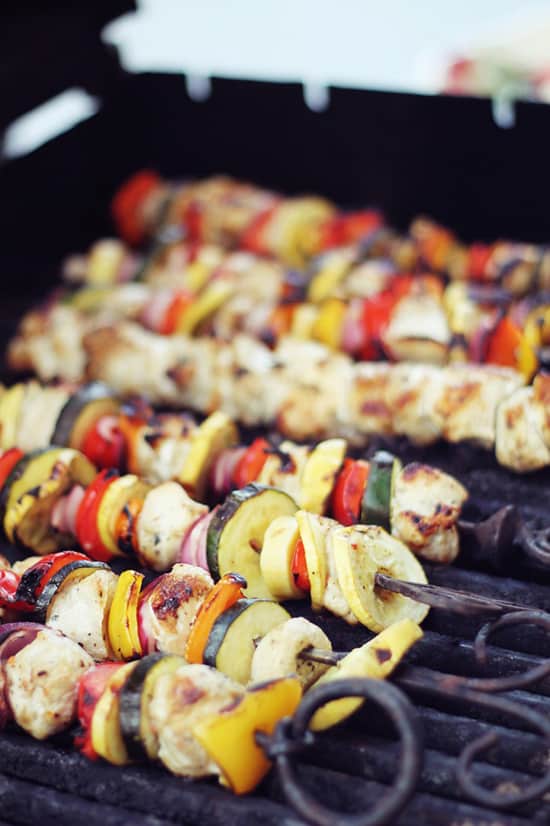 Seven Chicken Kabobs on Top of a Grill