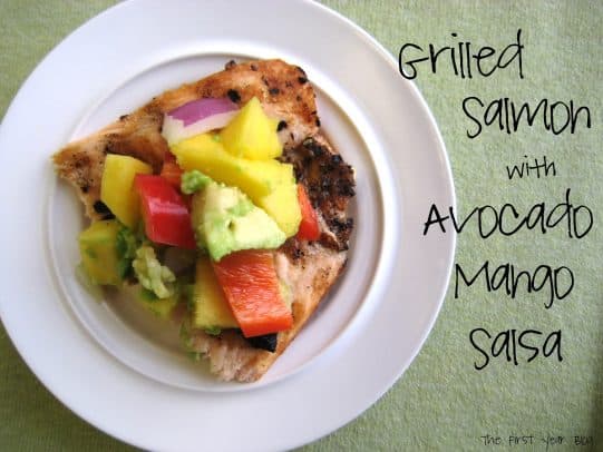 A White Plate of Grilled Salmon Topped with Avocado Mango Salsa