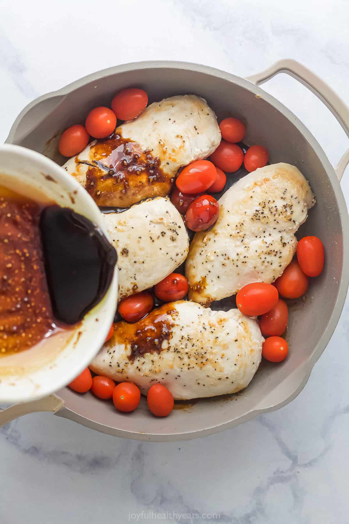 Pouring the sauce into the skillet. 