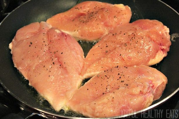 Chicken breast cooking in a skillet