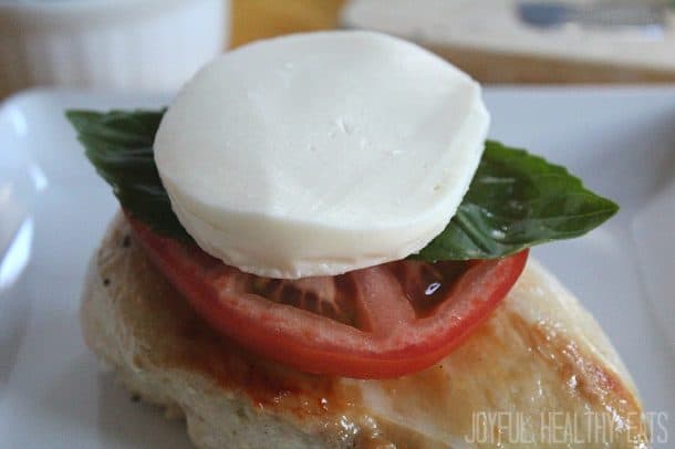 Chicken breast with sliced tomato, fresh basil, and a slice of fresh mozzarella