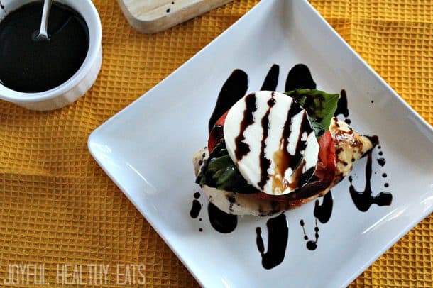 Caprese chicken stack on a plate with balsamic drizzle