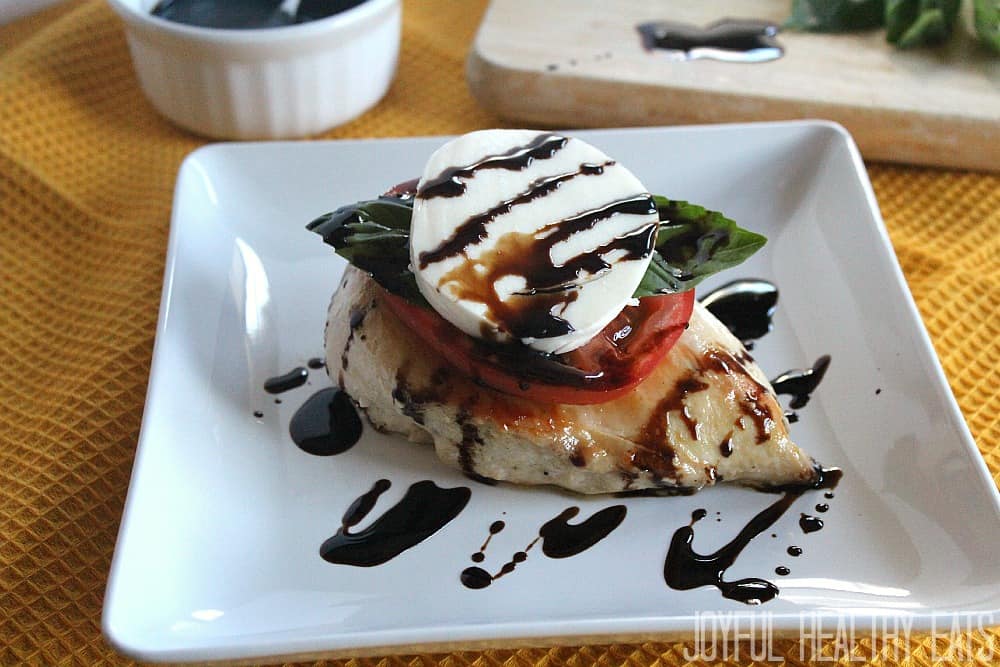 Caprese Chicken breast on a plate with balsamic drizzle