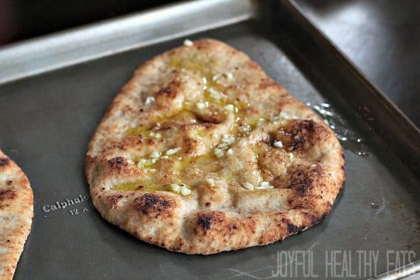 Flatbread with garlic and olive oil on a baking sheet
