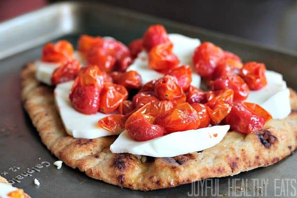 Flatbread topped with fresh sliced mozzarella and roasted grape tomatoes