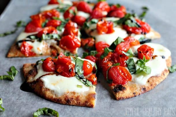 Six Slices of Caprese Flatbread on a Piece of Wax Paper