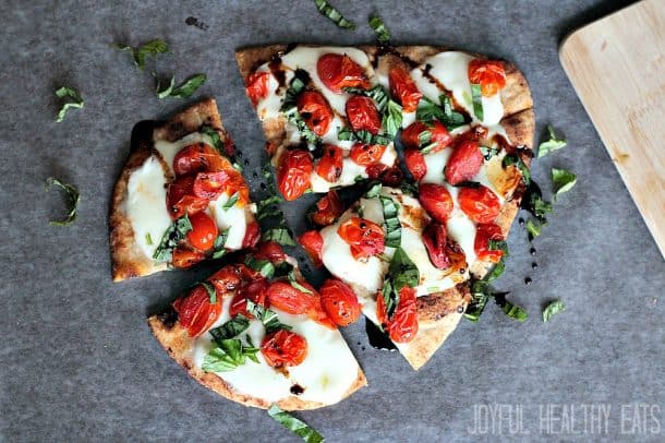 Flatbread topped with fresh mozzarella, roasted grape tomatoes and fresh basil cut into 4 pieces