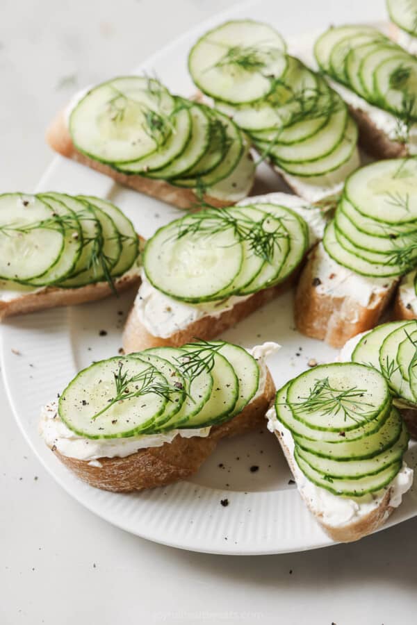 Cucumber sandwiches with a smooth cream cheese-dill mixture on top.