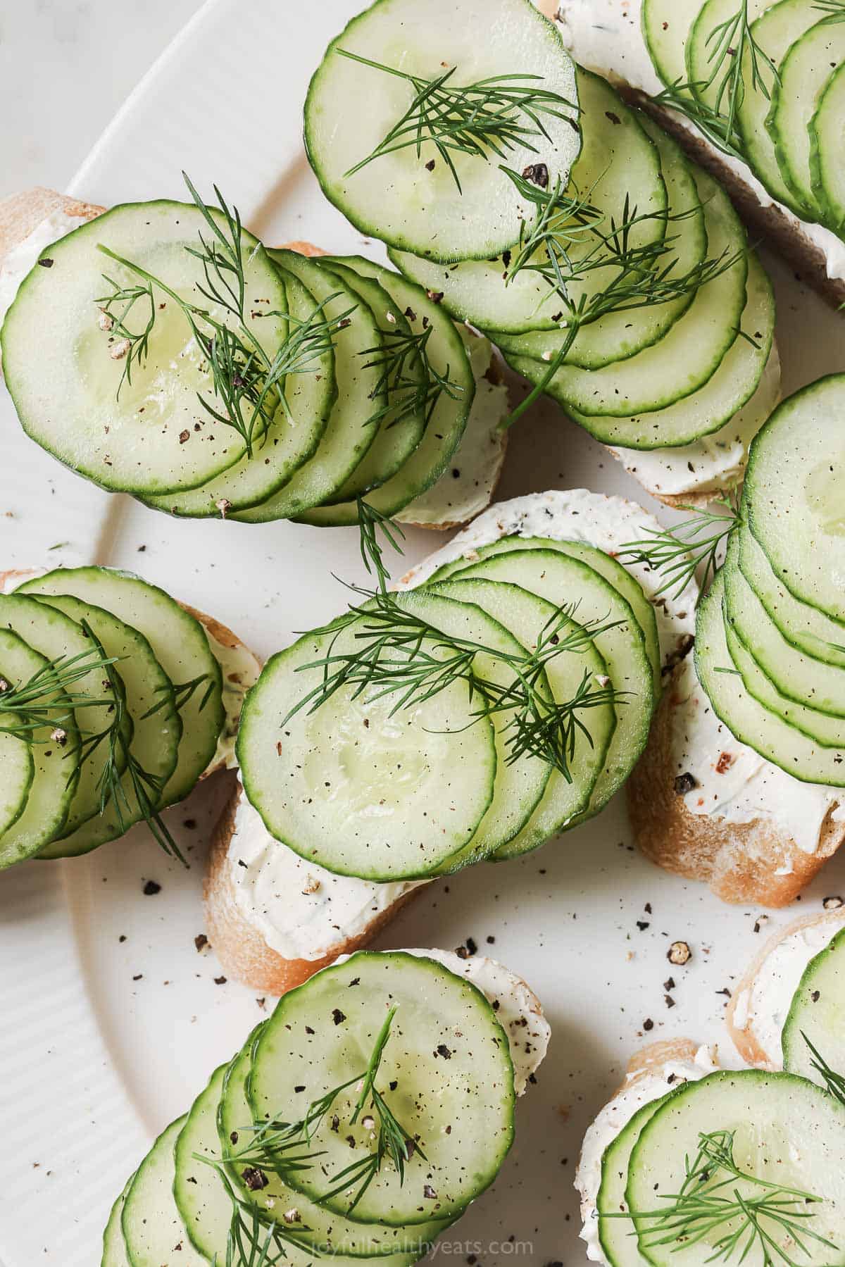 Cucumber sandwiches with fresh dill on top.